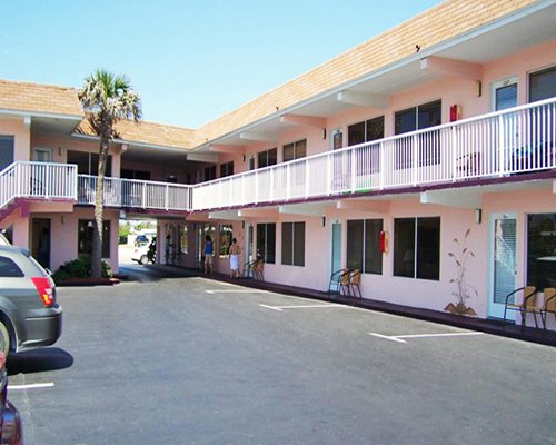 Exterior view of Club Sea Oats resort with a parking lot.