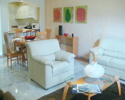 A well furnished living and dining area alongside a kitchen.