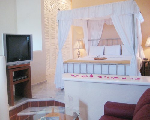 A well furnished bedroom with television.