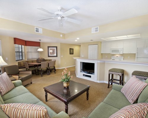 A well furnished living room with dining area and outside view.