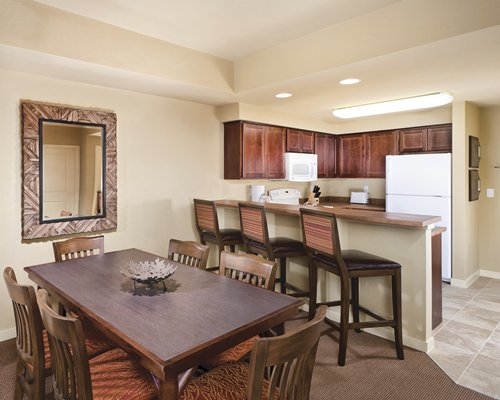 An open plan dining and kitchen area with a breakfast bar.