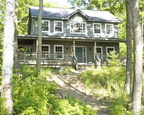 An exterior view of a resort unit surrounded by trees.