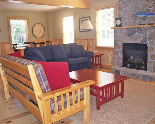 An open plan living and dining area with a fireplace and outside view.