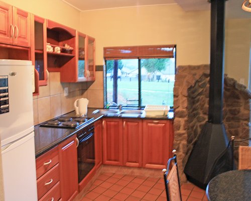 An open plan dining and kitchen area with an outside view.