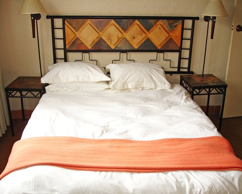 A well furnished bedroom with a double bed.
