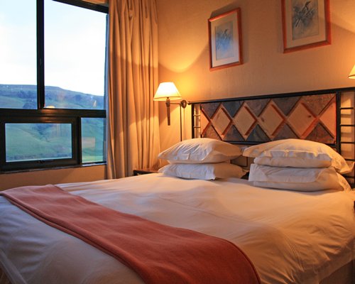 A well furnished bedroom with a double bed and outside view.