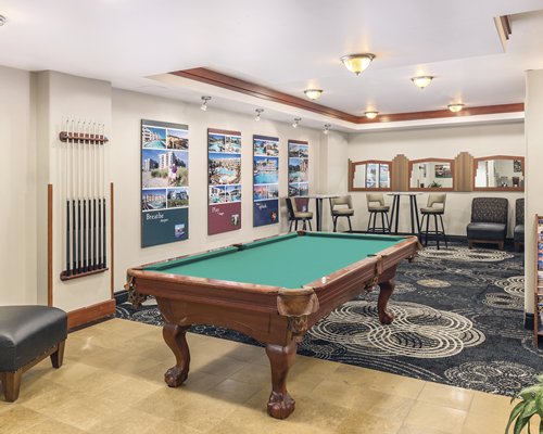 An indoor recreation room with pool table.
