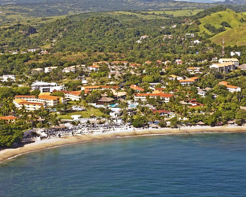 An aerial view of The Crown Suites at LHVC Resort alongside the ocean.