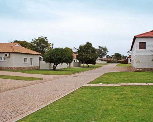 An exterior view of resort units alongside a well maintained lawn.