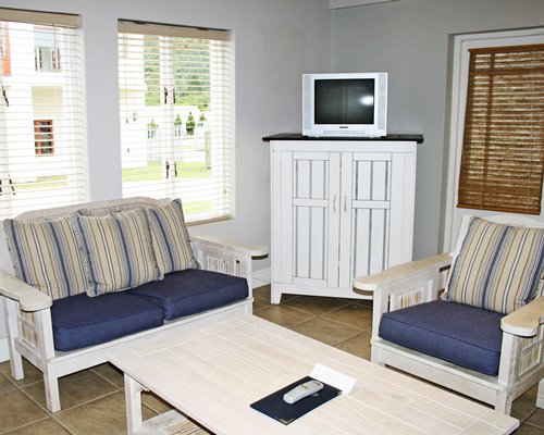 A well furnished living room with a television and patio.