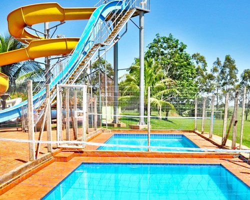 A view of two kiddie pool alongside water slides.