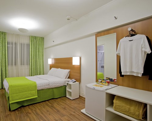 A well furnished bedroom with an outside view.