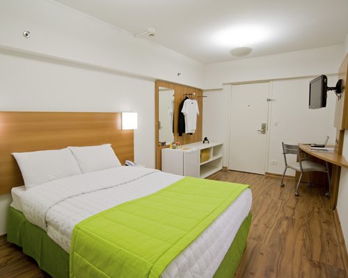 A well furnished bedroom with a television.