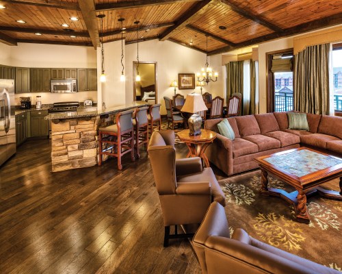 AN OPEN PLAN LIVING DINING AND KITCHEN AREA WITH BREAKFAST BAR.