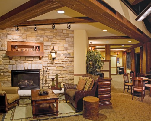AN OPEN PLAN LIVING AND DINING AREA WITH A FIREPLACE.