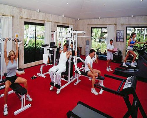 A well equipped fitness center with an outside view.