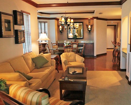 An open plan living and dining area with a queen pull out sofa.
