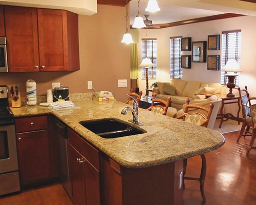 An open plan living dining and kitchen area with a breakfast bar.