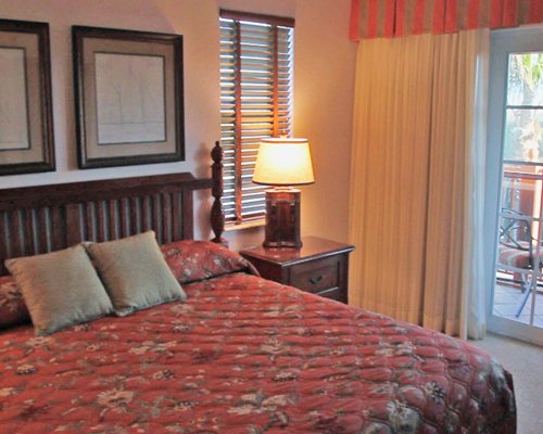 A well furnished bedroom with a balcony.