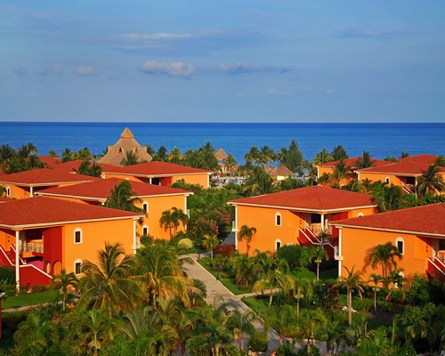 Exterior view of the Ocean Maya Royale resort alongside the sea.