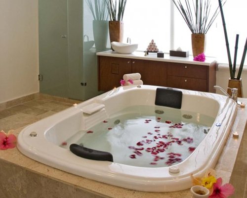 A jacuzzi tub with flower petals.