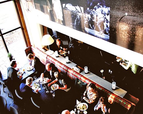 A group of people in the indoor fine dining restaurant.