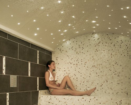 A girl relaxing in a steam room at the hotel.