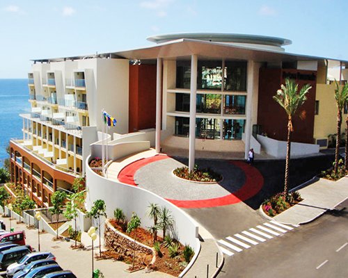 Exterior view of Pestana Promenade Hotel Ocean Resort with parking lot.