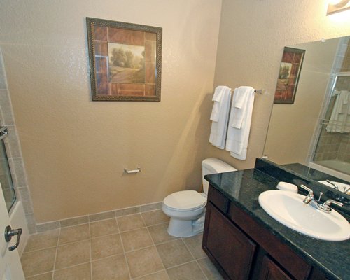 A bathroom with shower stall and closed sink vanity.