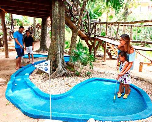 A family playing miniature golf.