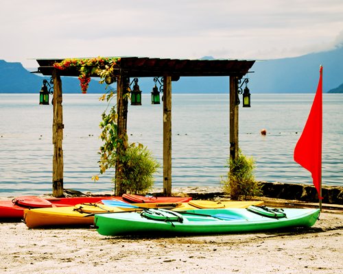 A beachside gazebo with boats.