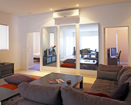 A well furnished living room with television and dining area.