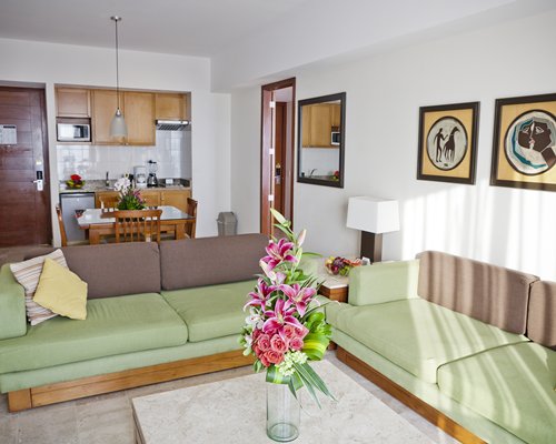 A well furnished living room with an open plan kitchen and dining area.