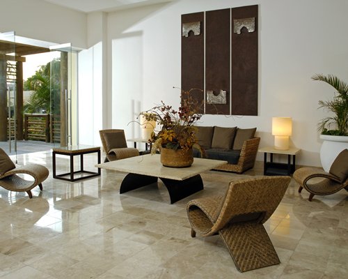 A well furnished living room with chaise lounge chairs and an outdoor patio.