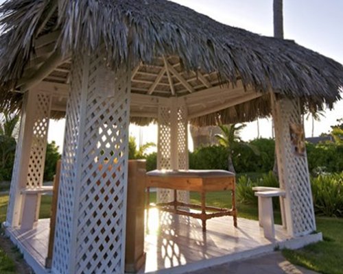 A gazebo with a thatched roof.