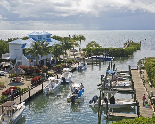 An exterior view of the resort and a marina alongside the ocean.