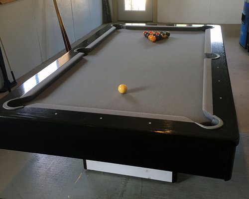 An indoor recreational area with pool table.
