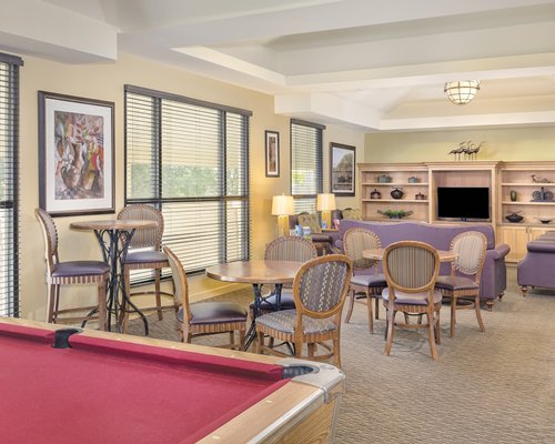 An indoor recreational room with pool table and television.