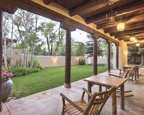 An indoor recreation area with patio furniture alongside a well maintained lawn.