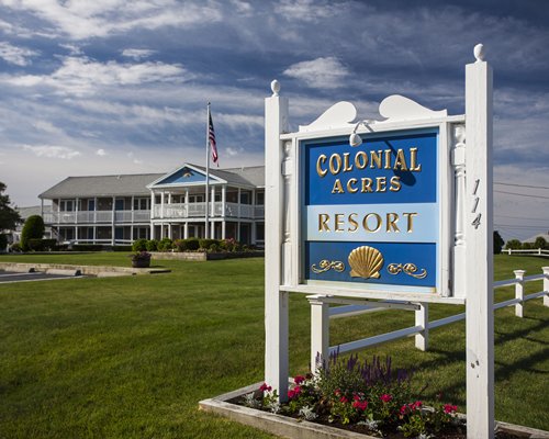Signboard of Colonial Acres Resort alongside multi story resort units.