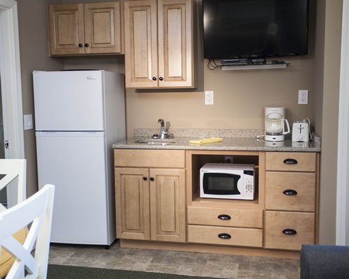 A well equipped kitchen with a television.