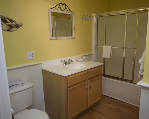A bathroom with bathtub and closed sink vanity.