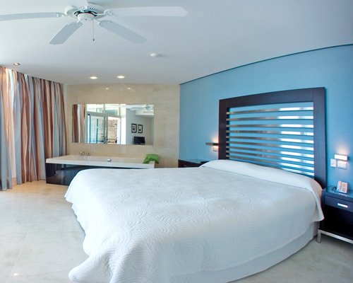 A well furnished bedroom with bathtub.