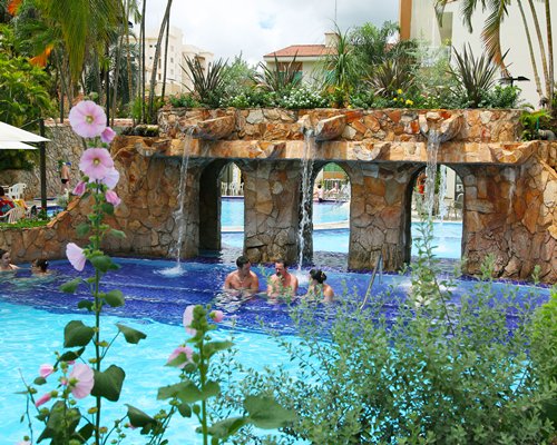 An outdoor swimming pool with water fountain.