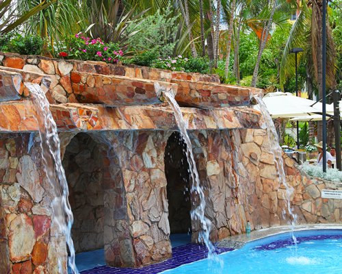 An outdoor swimming pool with water features.