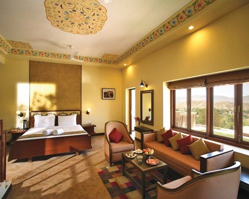 An open plan bedroom and living area with an outside view.
