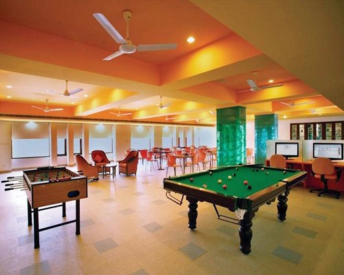An indoor recreation room with pool table and table soccer.