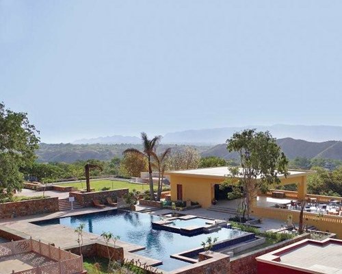 An outdoor swimming pool with chaise lounge chairs.