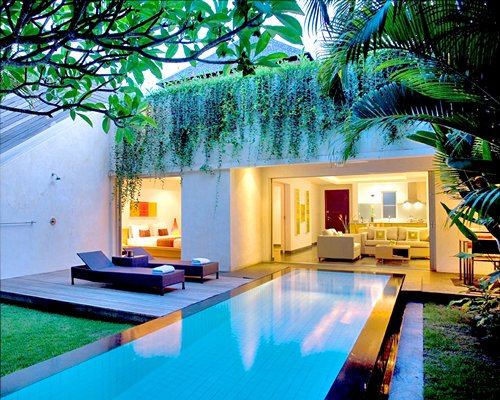 An outdoor pool alongside a resort unit.