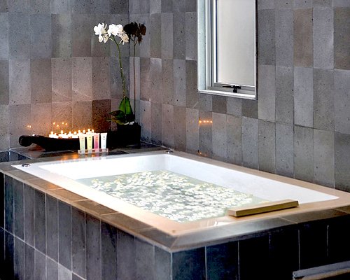 A bathtub set in granite tile.
